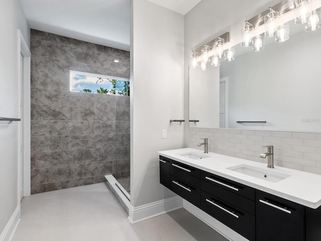 bathroom featuring vanity, a tile shower, backsplash, and tile patterned floors