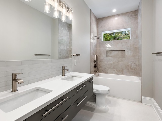 full bathroom with backsplash, toilet, vanity, tiled shower / bath combo, and tile patterned flooring