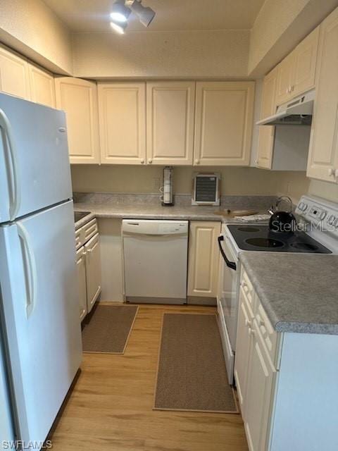 kitchen with white appliances, under cabinet range hood, light wood finished floors, and white cabinetry