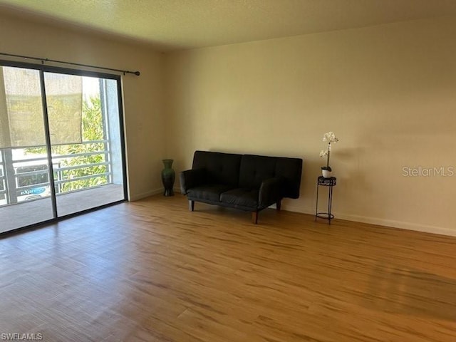 sitting room featuring hardwood / wood-style flooring and a textured ceiling