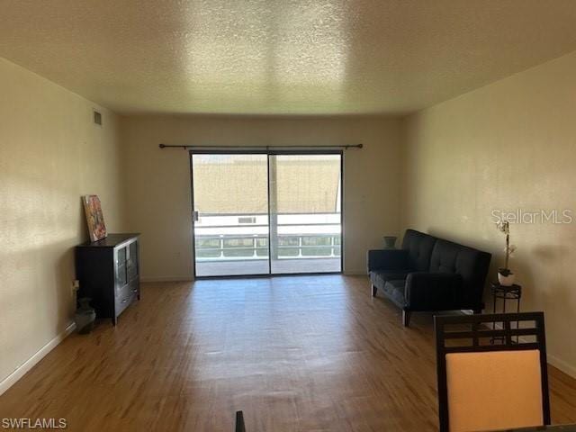 interior space featuring hardwood / wood-style floors and a textured ceiling