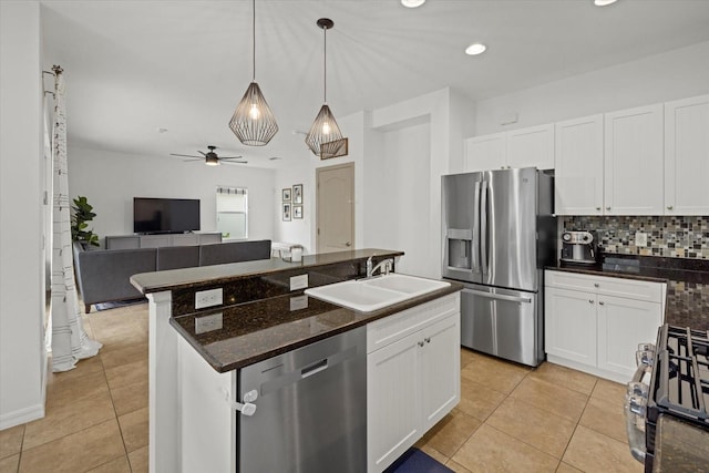 12224 Longview Lake Cir, Bradenton, FL 34211 - kitchen featuring stainless steel appliances, a sink, light tile patterned floors, open floor plan, and backsplash