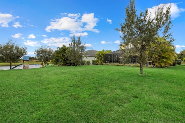 view of yard with a playground and a lanai