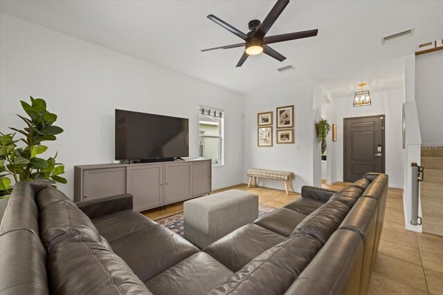 living room featuring visible vents, a ceiling fan, and light tile patterned flooring