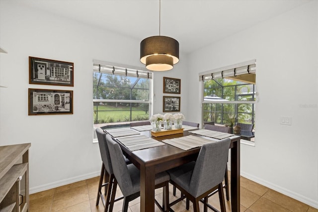 dining area featuring baseboards and light tile patterned flooring