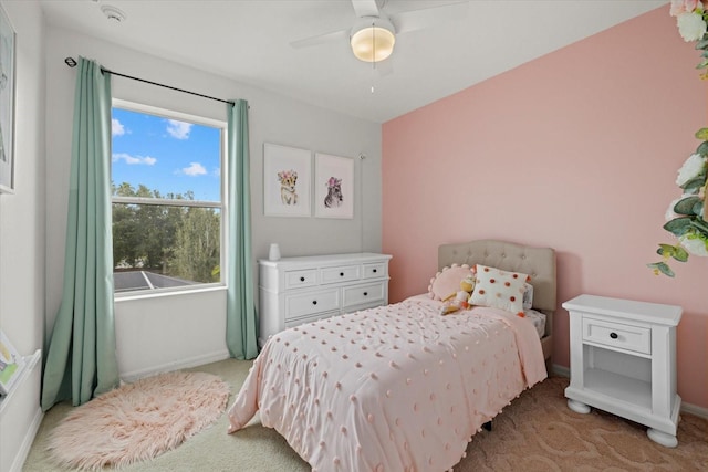 bedroom with baseboards, ceiling fan, and light colored carpet