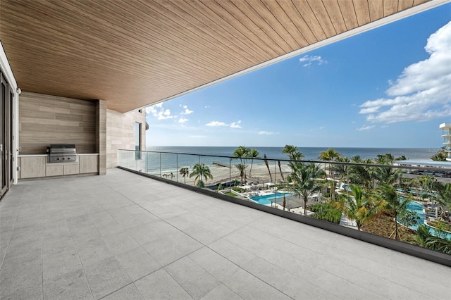 balcony with a grill and a water view