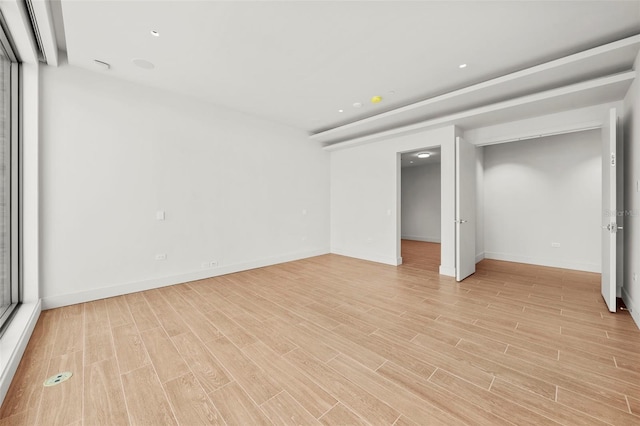 unfurnished bedroom with light wood-type flooring