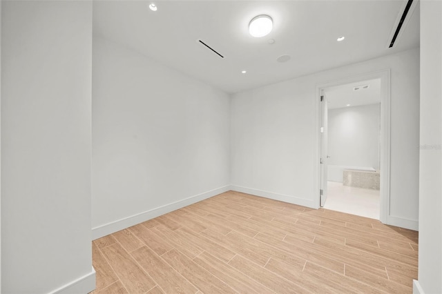 unfurnished room with light hardwood / wood-style floors