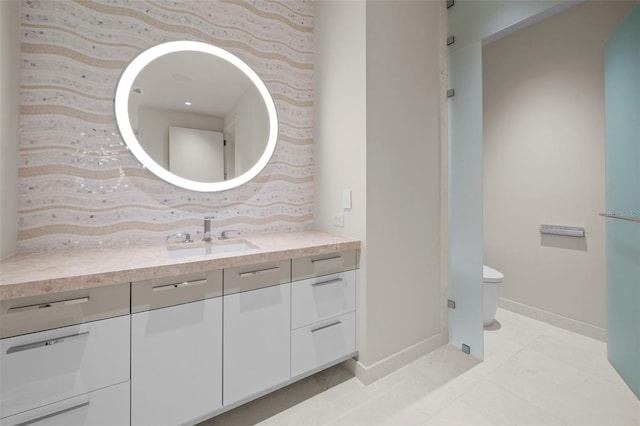 bathroom featuring toilet, vanity, and tile patterned floors