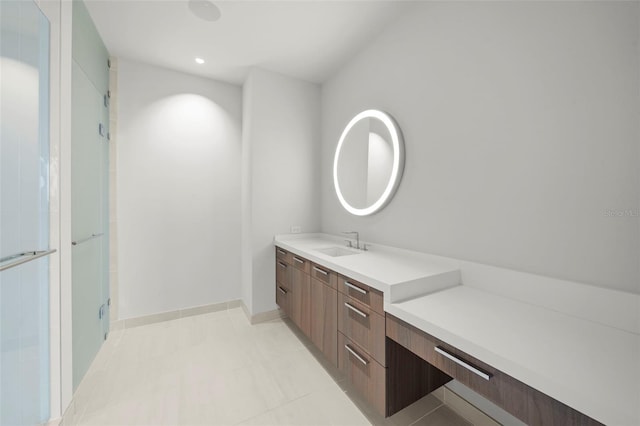 bathroom with vanity, tile patterned floors, and a shower with door