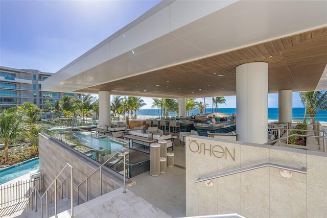 view of patio with a water view and a balcony