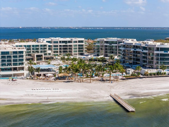 bird's eye view featuring a water view and a beach view