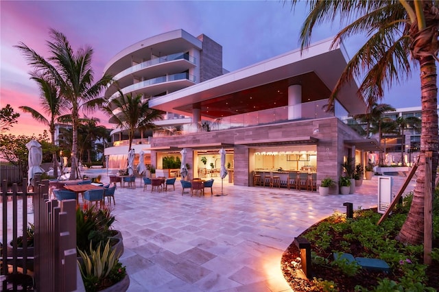 patio terrace at dusk featuring an outdoor bar