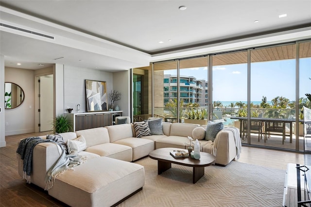 1591 Gulf Of Mexico Dr Unit 311, Longboat Key, FL 34228 - living room featuring wood finished floors, baseboards, visible vents, and expansive windows
