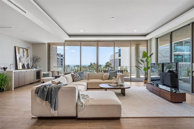 1591 Gulf Of Mexico Dr Unit 311, Longboat Key, FL 34228 - living room with a wall of windows and wood finished floors