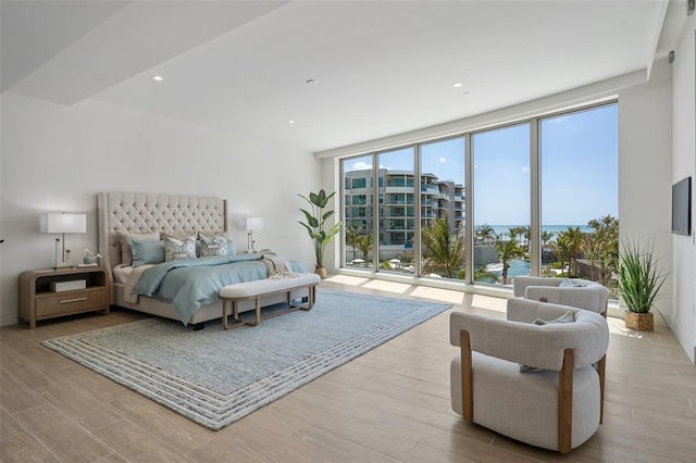 1591 Gulf Of Mexico Dr Unit 311, Longboat Key, FL 34228 - bedroom with recessed lighting, expansive windows, baseboards, and wood finished floors