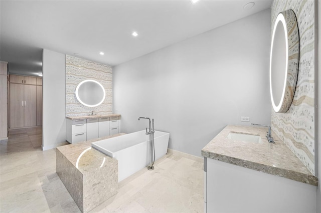1591 Gulf Of Mexico Dr Unit 311, Longboat Key, FL 34228 - bathroom with baseboards, a freestanding bath, a sink, recessed lighting, and two vanities