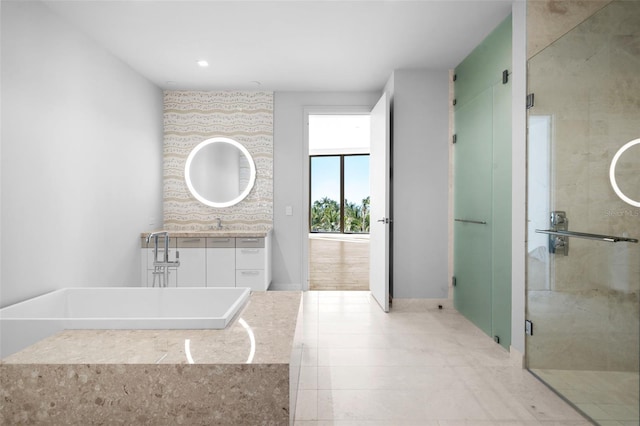 1591 Gulf Of Mexico Dr Unit 311, Longboat Key, FL 34228 - bathroom featuring a stall shower, a soaking tub, and vanity