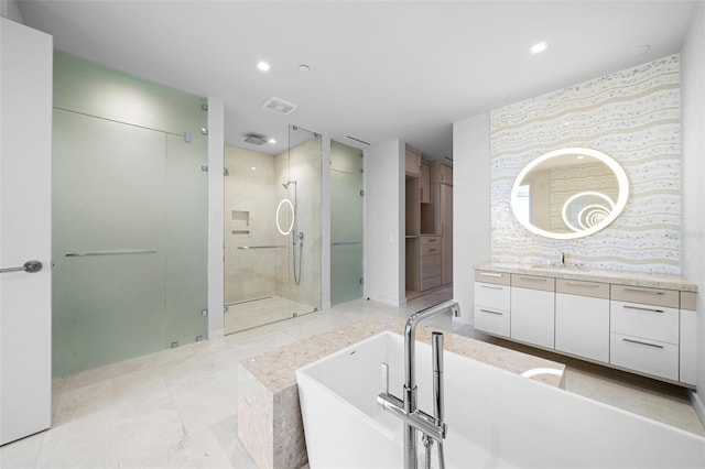 1591 Gulf Of Mexico Dr Unit 311, Longboat Key, FL 34228 - full bathroom with visible vents, a soaking tub, recessed lighting, vanity, and a stall shower