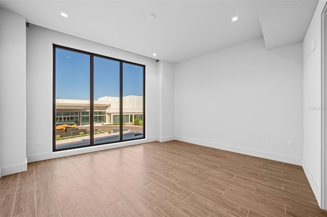 1591 Gulf Of Mexico Dr Unit 311, Longboat Key, FL 34228 - spare room featuring wood finished floors and baseboards