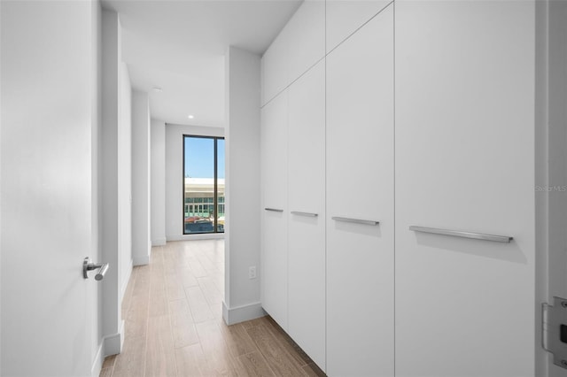 1591 Gulf Of Mexico Dr Unit 311, Longboat Key, FL 34228 - hall featuring light wood-style flooring and baseboards