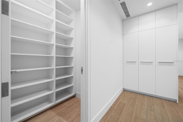 1591 Gulf Of Mexico Dr Unit 311, Longboat Key, FL 34228 - spacious closet with visible vents and wood finished floors