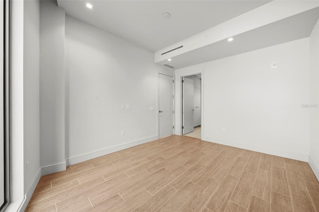 empty room with light hardwood / wood-style flooring