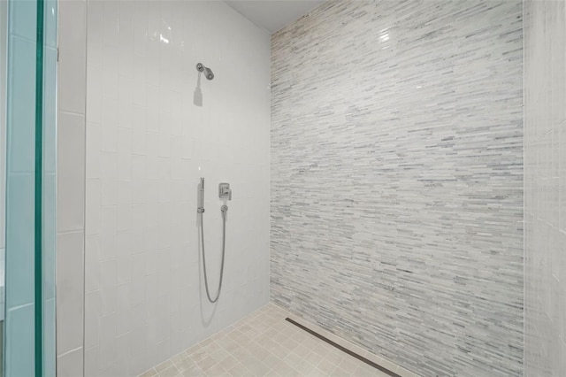 bathroom with tiled shower