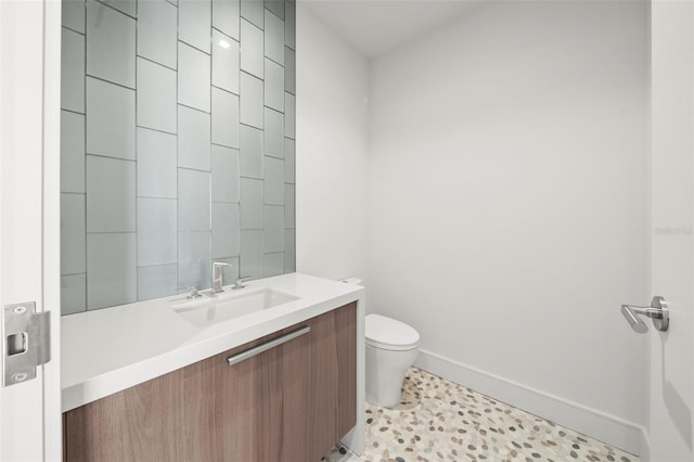 bathroom with tile patterned floors, vanity, and toilet