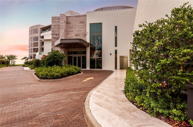 view of outdoor building at dusk