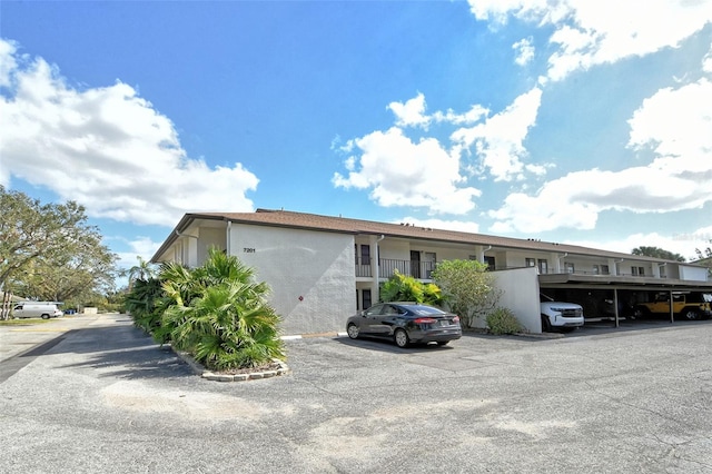 view of front facade featuring a balcony and a carport