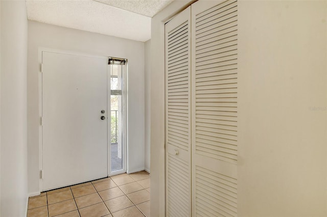 tiled entrance foyer featuring a textured ceiling