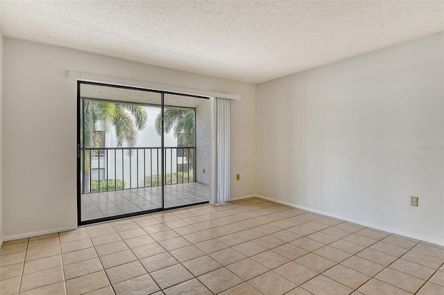 unfurnished room featuring a textured ceiling and light tile patterned floors