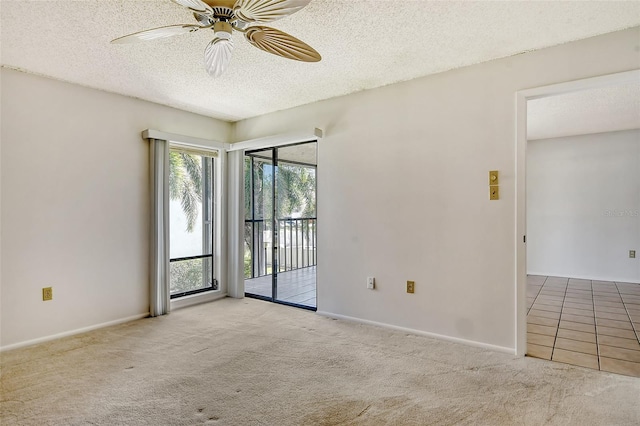 empty room featuring a textured ceiling, light carpet, and ceiling fan