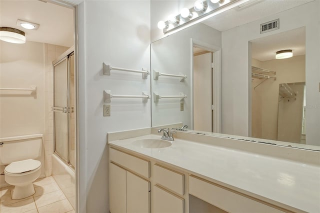 full bathroom with toilet, vanity, tile patterned flooring, and shower / bath combination with glass door