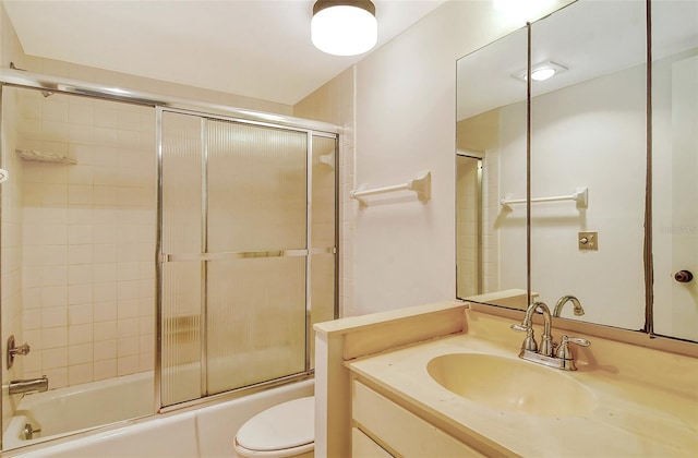 full bathroom with shower / bath combination with glass door, vanity, and toilet