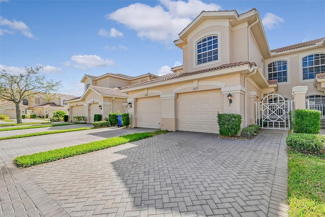 mediterranean / spanish-style house with a garage