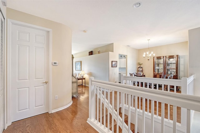 4517 Streamside Ct Unit 1905, Sarasota, FL 34238 - hall featuring wood finished floors, a chandelier, and baseboards
