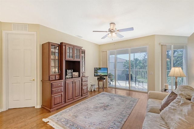 living room featuring ceiling fan and light wood-type flooring