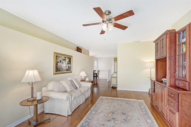 living room with hardwood / wood-style flooring and ceiling fan