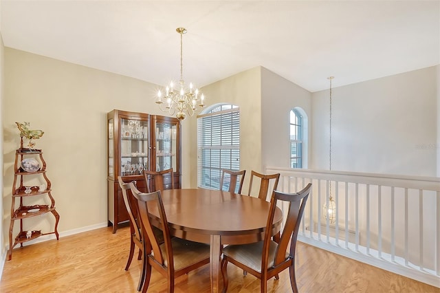 dining room with an inviting chandelier and light hardwood / wood-style flooring