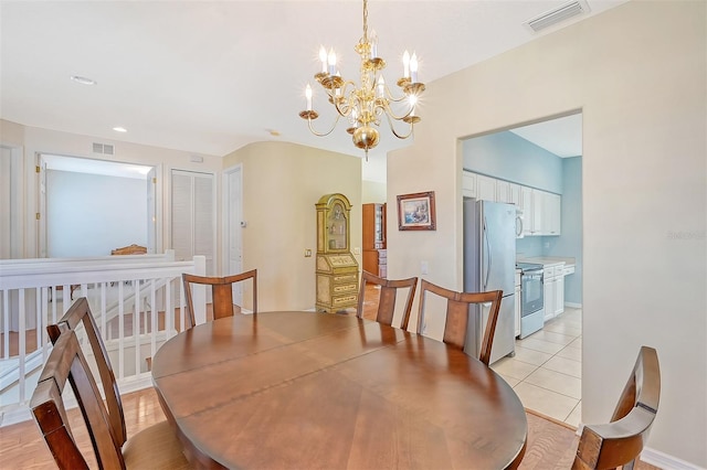 tiled dining space with a notable chandelier