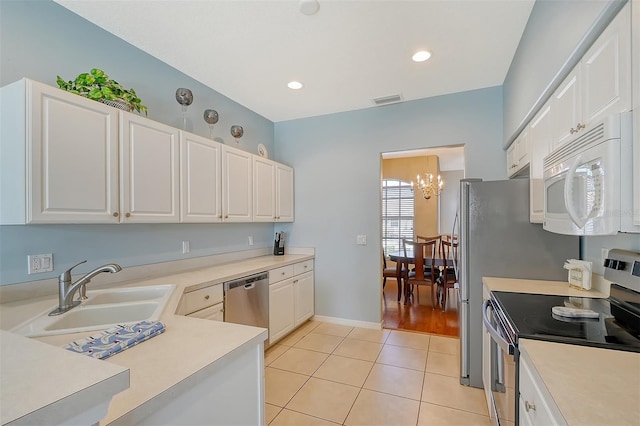 4517 Streamside Ct Unit 1905, Sarasota, FL 34238 - kitchen with appliances with stainless steel finishes, a sink, a chandelier, light tile patterned floors, and light countertops