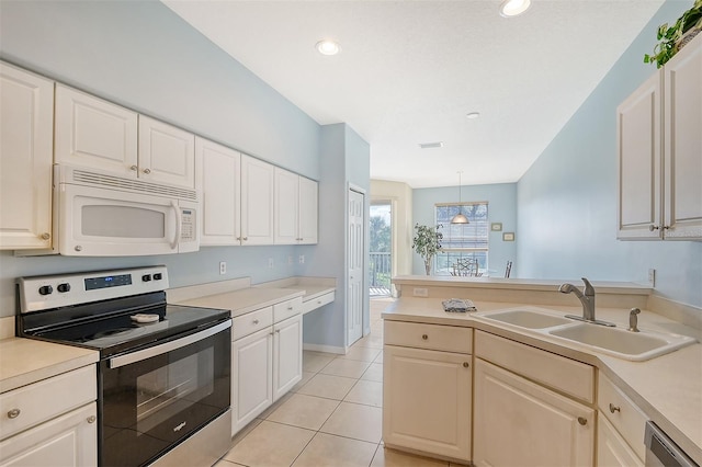 kitchen with stainless steel appliances, sink, decorative light fixtures, and light tile patterned floors