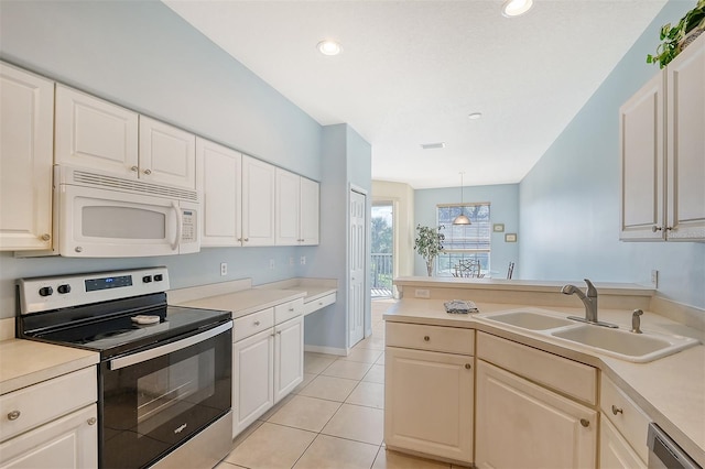 4517 Streamside Ct Unit 1905, Sarasota, FL 34238 - kitchen featuring stainless steel appliances, a sink, a peninsula, light countertops, and light tile patterned flooring