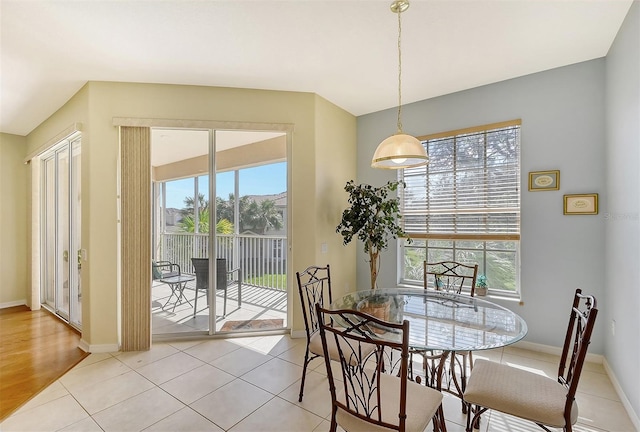 dining area with light wood-type flooring and plenty of natural light