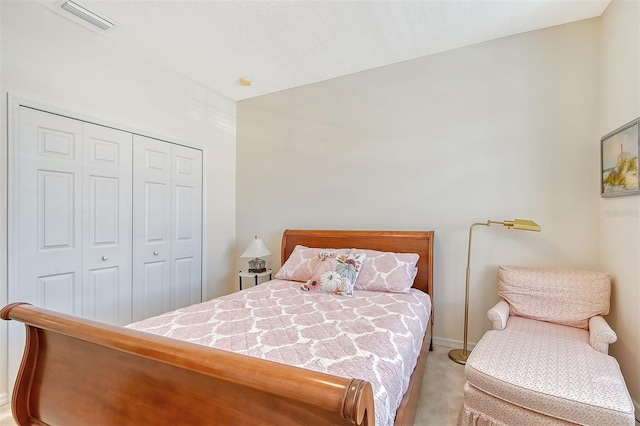 bedroom with light carpet and a closet