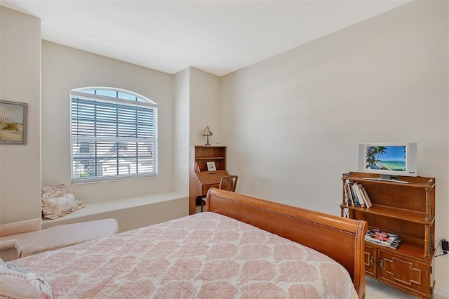 bedroom featuring light carpet