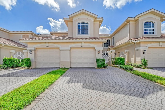 mediterranean / spanish house featuring a garage